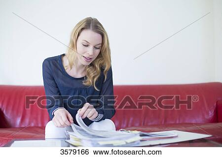 Pretty blonde woman checking bills at home View Large Photo Image Stock Photograph - Pretty blonde woman checking bills at home. Fotosearch