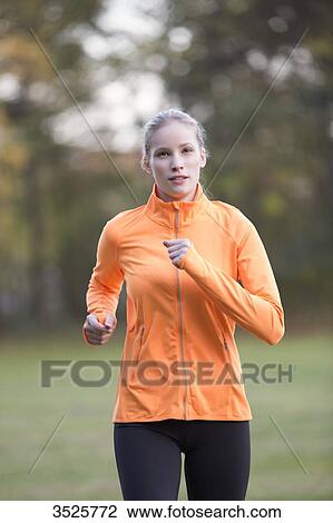 Pretty blonde woman doing jogging in park View Large Photo Image Stock Image - Pretty blonde woman doing jogging in park. Fotosearch