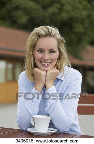 Pretty blonde woman in a Cafe smiling at camera View Large Photo Image Stock Photograph - Pretty blonde woman in a Cafe smiling at camera. Fotosearch