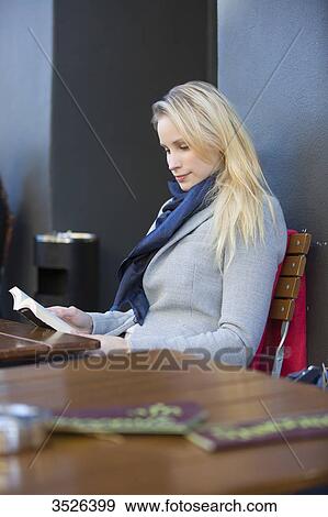 Pretty blonde woman reading a book in a Cafe in downtown View Large Photo Image Stock Photo - Pretty blonde woman reading a book in a Cafe in downtown. Fotosearch