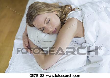 Pretty blonde woman sleeping in bed View Large Photo Image Stock Image - Pretty blonde woman sleeping in bed. Fotosearch