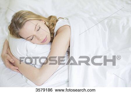 Pretty blonde woman sleeping in bed View Large Photo Image Stock Photograph - Pretty blonde woman sleeping in bed. Fotosearch