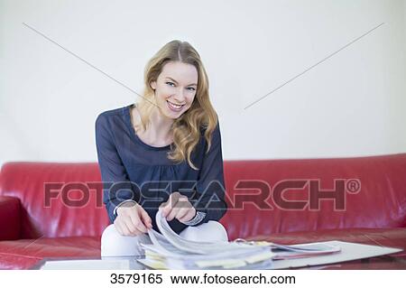 Pretty blonde woman with bills at home smiling at camera View Large Photo Image Stock Photography - Pretty blonde woman with bills at home smiling at camera. Fotosearch