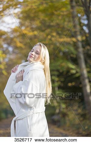 Pretty blonde woman with coat in Park in Autumn View Large Photo Image Stock Photo - Pretty blonde woman with coat in Park in Autumn. Fotosearch