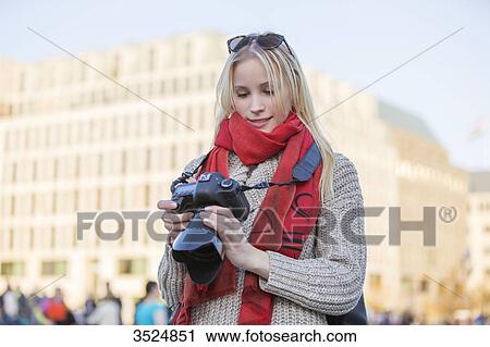 Pretty blonde woman with digital camera taking photos in a city in Europe View Large Photo Image Stock Image - Pretty blonde woman with digital camera taking photos in a city in Europe. Fotosearch