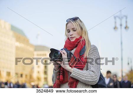 Pretty blonde woman with digital camera taking photos in a city in Europe View Large Photo Image Stock Photo - Pretty blonde woman with digital camera taking photos in a city in Europe. Fotosearch