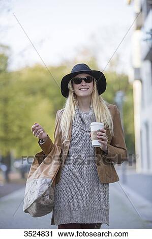 Pretty blonde woman with hat, sunglasses and coffee to go walking in City Center View Large Photo Image Stock Image - Pretty blonde woman with hat, sunglasses and coffee to go walking in City Center. Fotosearch