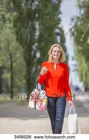 Pretty blonde woman with shooping bags View Large Photo Image Stock Photograph - Pretty blonde woman with shooping bags. Fotosearch