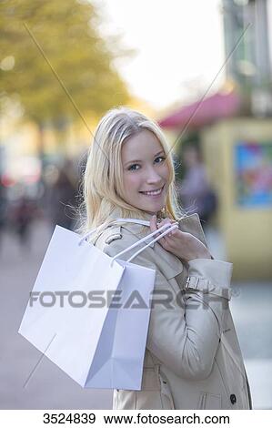 Pretty blonde woman with shopping bags walking in downtown View Large Photo Image Stock Photo - Pretty blonde woman with shopping bags walking in downtown. Fotosearch