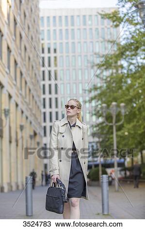 Pretty business woman with bag walking in town View Large Photo Image Stock Image - Pretty business woman with bag walking in town. Fotosearch