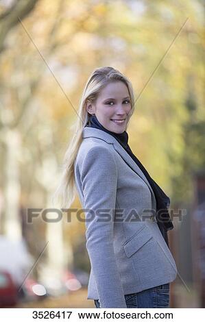 Pretty elegant woman walking in citycenter and smiling at camera View Large Photo Image Stock Photo - Pretty elegant woman walking in citycenter and smiling at camera. Fotosearch
