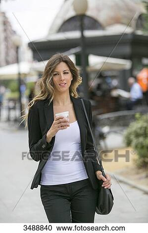 Pretty executive woman walking in downtown View Large Photo Image Stock Image - Pretty executive woman walking in downtown. Fotosearch