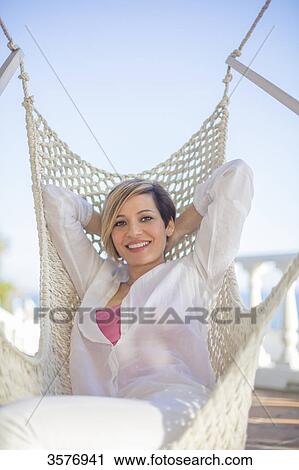 Pretty woman leaning in Hammock, smiling at camera View Large Photo Image Stock Image - Pretty woman leaning in Hammock, smiling at camera. Fotosearch