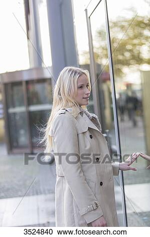 Pretty woman looking at showcase in downtown View Large Photo Image Stock Image - Pretty woman looking at showcase in downtown. Fotosearch