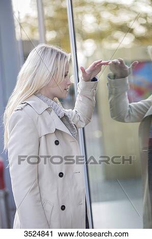 Pretty woman looking at showcase in downtown View Large Photo Image Stock Image - Pretty woman looking at showcase in downtown. Fotosearch