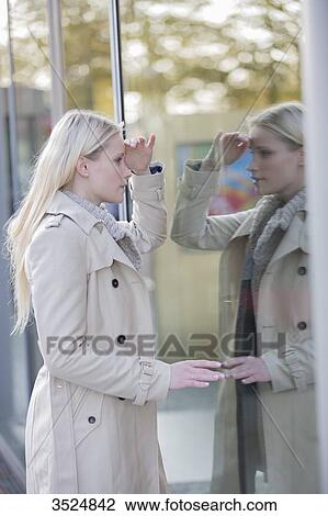 Pretty woman looking at showcase in downtown View Large Photo Image Stock Image - Pretty woman looking at showcase in downtown. Fotosearch