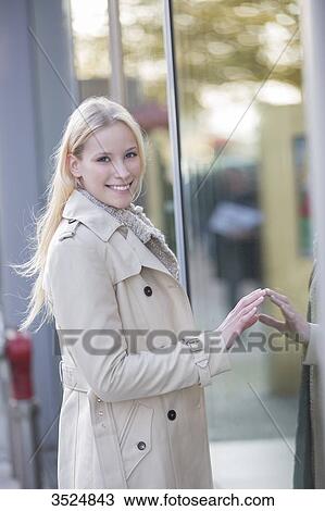 Pretty woman looking at showcase in downtown View Large Photo Image Stock Image - Pretty woman looking at showcase in downtown. Fotosearch