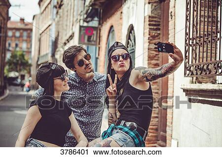 Selfie of three young people in an urban landscape View Large Photo Image Stock Image - Selfie of three young people in an urban landscape. Fotosearch