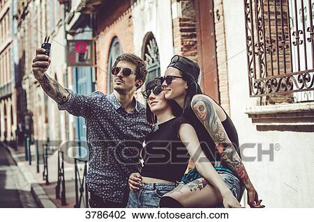 Selfie of three young people in an urban landscape View Large Photo Image Stock Image - Selfie of three young people in an urban landscape. Fotosearch
