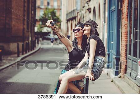 Stock Image - Selfie of two young women in an urban landscape. Fotosearch