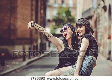 Selfie of two young women in an urban landscape View Large Photo Image Stock Image - Selfie of two young women in an urban landscape. Fotosearch