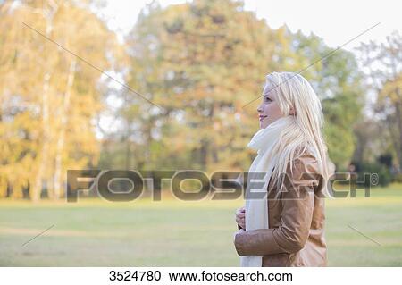 Side view of a pretty blonde woman in Park in Autumn View Large Photo Image Stock Image - Side view of a pretty blonde woman in Park in Autumn. Fotosearch
