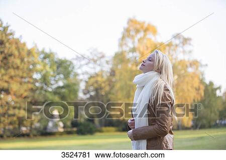 Side view of a pretty blonde woman in Park in Autumn with eyes closed View Large Photo Image Stock Image - Side view of a pretty blonde woman in Park in Autumn with eyes closed. Fotosearch