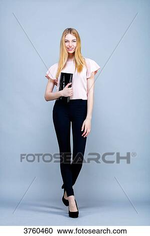Smiling young woman in the foot, a hand bag, looking to the Lens View Large Photo Image Stock Image - Smiling young woman in the foot, a hand bag, looking to the Lens. Fotosearch