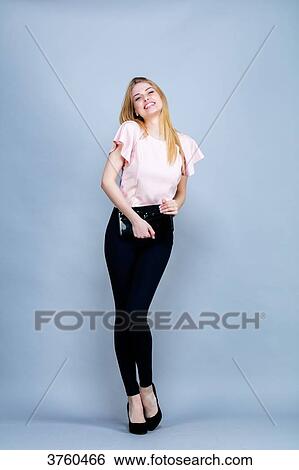 Smiling young woman in the foot, a hand bag, looking to the lens View Large Photo Image Stock Photograph - Smiling young woman in the foot, a hand bag, looking to the lens. Fotosearch