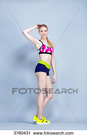 Smiling young woman Length, practical fitness exercises, one arm behind his head View Large Photo Image Stock Image - Smiling young woman Length, practical fitness exercises, one arm behind his head. Fotosearch