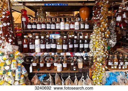 Stock Image - South America, Amazon, Belem, stall of vials and medicinal herbs at the Belem market. Fotosearch