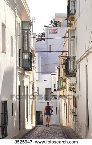 Stock Photo - Spain, Andalusia, Tarifa, tourist in a narrow street. Fotosearch