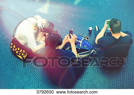 Stock Image - Three sitted teenagers.. Fotosearch