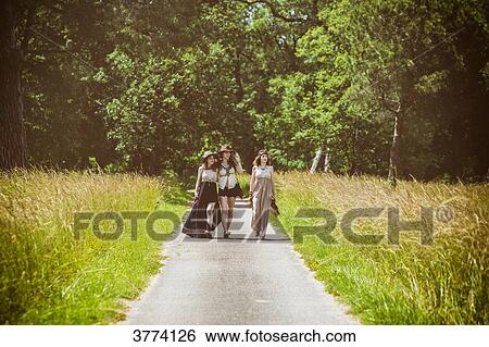 Three young Hipster face, walking on the country road View Large Photo Image Stock Photograph - Three young Hipster face, walking on the country road. Fotosearch
