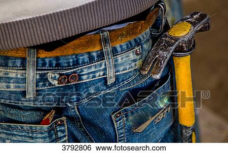 Tools close up on a denim worker View Large Photo Image Stock Photograph - Tools close up on a denim worker. Fotosearch