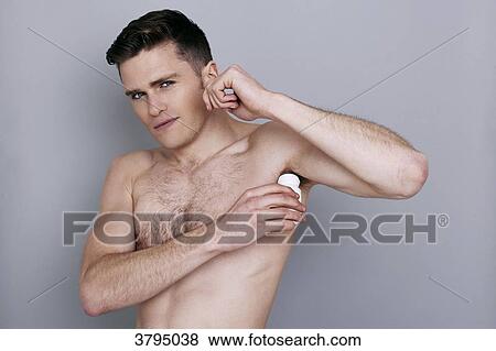 topless man, applying deodorant on his armpit View Large Photo Image Stock Photo - topless man, applying deodorant on his armpit. Fotosearch