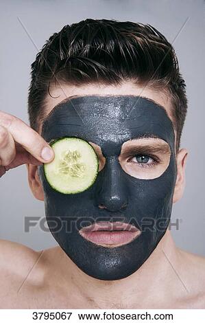 topless man, facemask on, looking at camera, serious, holding a slice of cucumber between his fingers, slice of cucumber in front of the eye View Large Photo Image Stock Photo - topless man, facemask on, looking at camera, serious, holding a slice of cucumber between his fingers, slice of cucumber in front of the eye. Fotosearch