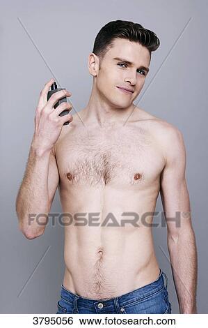 topless man, holding a bottle of perfume, spraying perfume on himself, looking at camera, wearing jeans, smiling View Large Photo Image Stock Photograph - topless man, holding a bottle of perfume, spraying perfume on himself, looking at camera, wearing jeans, smiling. Fotosearch