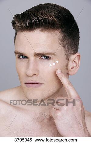 topless man, looking at camera, serious, applying dots of eye cream around the eye with his finger, dots of cream around the eye View Large Photo Image Stock Photography - topless man, looking at camera, serious, applying dots of eye cream around the eye with his finger, dots of cream around the eye. Fotosearch
