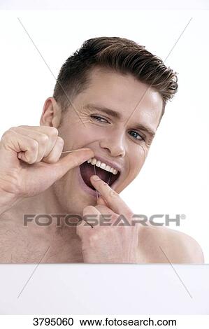 topless man, looking in the mirror, cleaning his teeth with dental floss. View Large Photo Image Stock Image - topless man, looking in the mirror, cleaning his teeth with dental floss.. Fotosearch