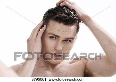 topless man, looking in the mirror, looking at his hair, hands in his hair, fixing his hair, serious View Large Photo Image Stock Image - topless man, looking in the mirror, looking at his hair, hands in his hair, fixing his hair, serious. Fotosearch