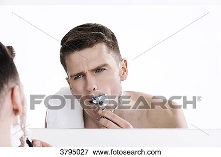 topless man, looking in the mirror, shaving his moustache, shaving his beard, with razor in his hands, shaving View Large Photo Image Stock Photo - topless man, looking in the mirror, shaving his moustache, shaving his beard, with razor in his hands, shaving. Fotosearch