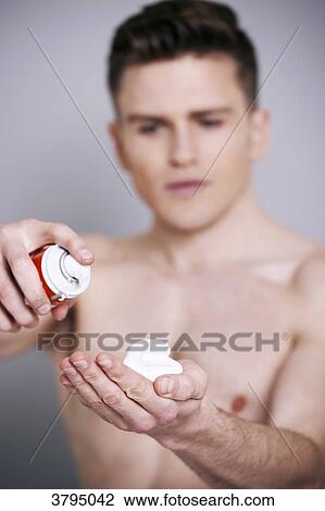 topless man, shaving cream in his hand, serious, looking at the shaving cream View Large Photo Image Stock Image - topless man, shaving cream in his hand, serious, looking at the shaving cream. Fotosearch