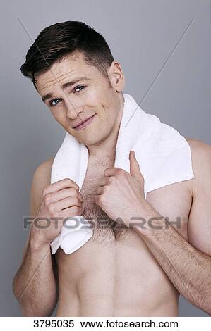 Stock Photography - topless man, towel around his neck, smiling, forehead creased. Fotosearch