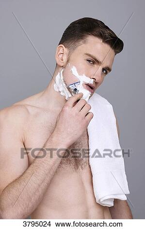 topless man, towel on his shoulder, with shaving cream on his half of his face, with razor in his hands, serious, shaving, mouth open View Large Photo Image Picture - topless man, towel on his shoulder, with shaving cream on his half of his face, with razor in his hands, serious, shaving, mouth open. Fotosearch