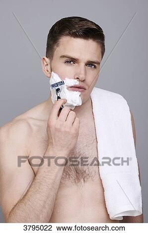 topless man, towel on his shoulder, with shaving cream on his half of his face, with razor in his hands, serious View Large Photo Image Stock Image - topless man, towel on his shoulder, with shaving cream on his half of his face, with razor in his hands, serious. Fotosearch