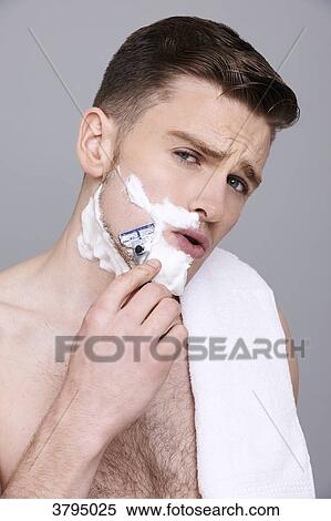 topless man, towel on his shoulder, with shaving cream on his half of his face, with razor in his hands, serious, shaving, mouth open View Large Photo Image Stock Photography - topless man, towel on his shoulder, with shaving cream on his half of his face, with razor in his hands, serious, shaving, mouth open. Fotosearch