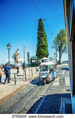 Tuk-Tuk on Avenue Largo das Portas do Sol, Alfama, Lisbon, Portugal View Large Photo Image Stock Photo - Tuk-Tuk on Avenue Largo das Portas do Sol, Alfama, Lisbon, Portugal. Fotosearch