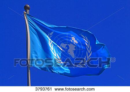 Stock Image - UN flag in blue sky.. Fotosearch