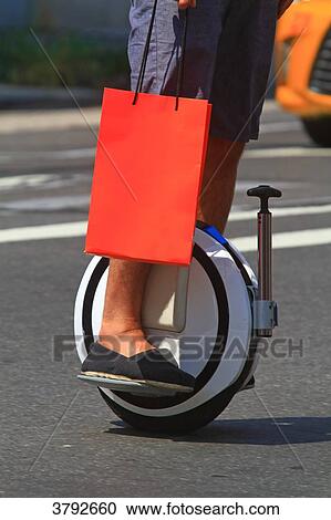 USA, New york. Man with electric wheel. View Large Photo Image Stock Image - USA, New york. Man with electric wheel.. Fotosearch